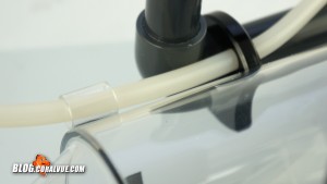 Attach the airline to the venturi elbow attached to the pump and then thread the line through the holding bracket.